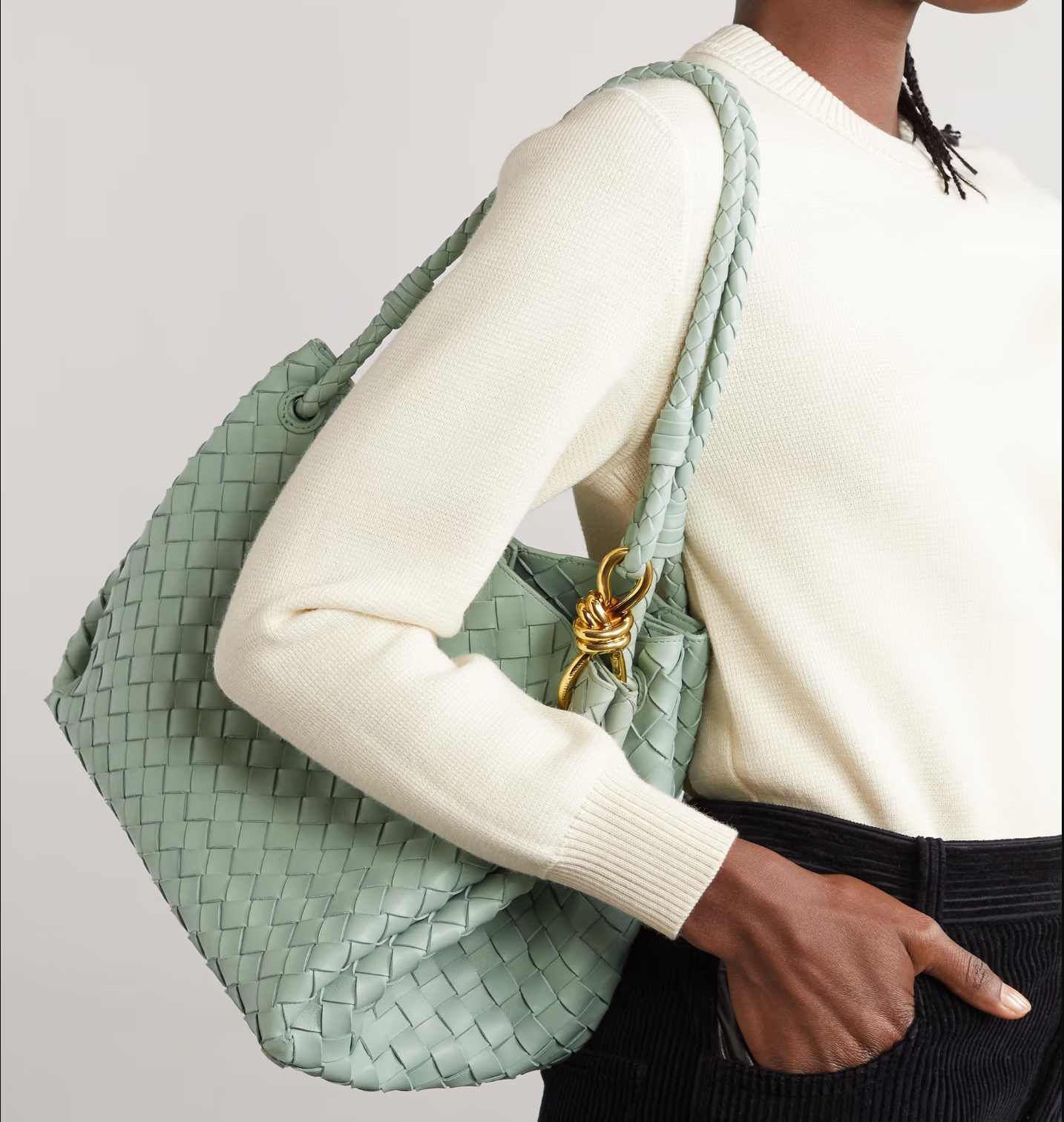 A stylish Bottega Veneta Cassette Padded Crossbody Bag in white leather with signature woven design, perfect for adding a modern touch to any outfit.