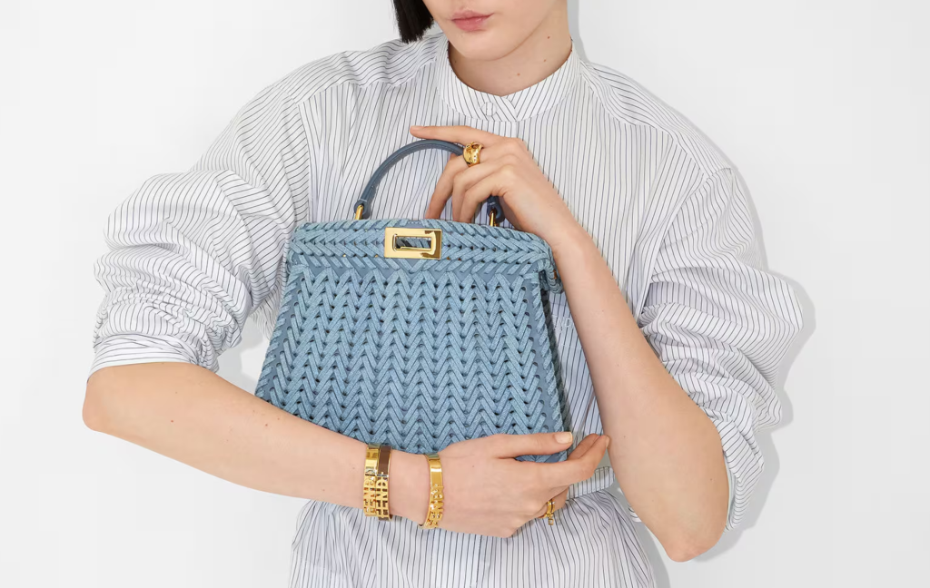  A compact replica mini woven handbag with intricate decorative weaving, perfect for carrying essentials in a chic, minimalist style.